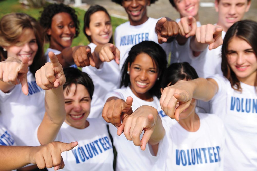 teen volunteers pointing at you