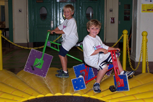 Square-wheeled tricycles that ride smoothly on a circular track are a highlight of the Math Midway exhibit at the New York Hall of Science. New York Hall of Science