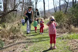 Hudson Highlands Nature Museum Outdoor Discovery Center; family on a nature walk in woods; nature hike with kids