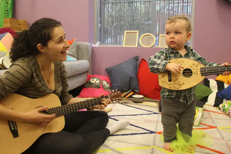 child and teacher playing with instruments