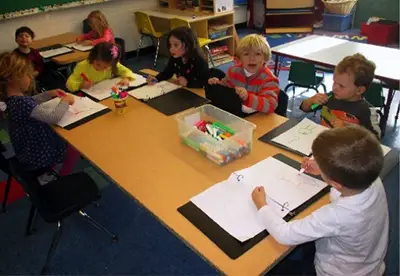 kids writing in journals in classroom