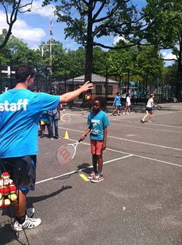 girl learning tennis