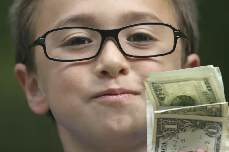 boy-holding-money