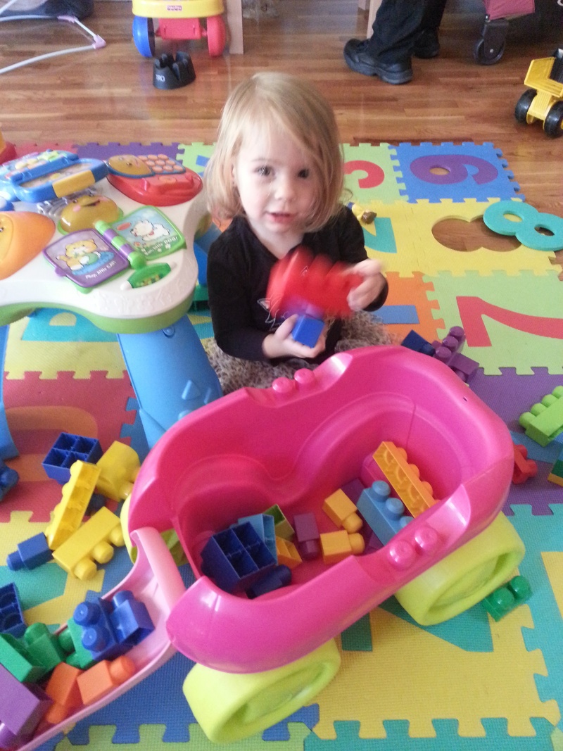 child playing with large legos